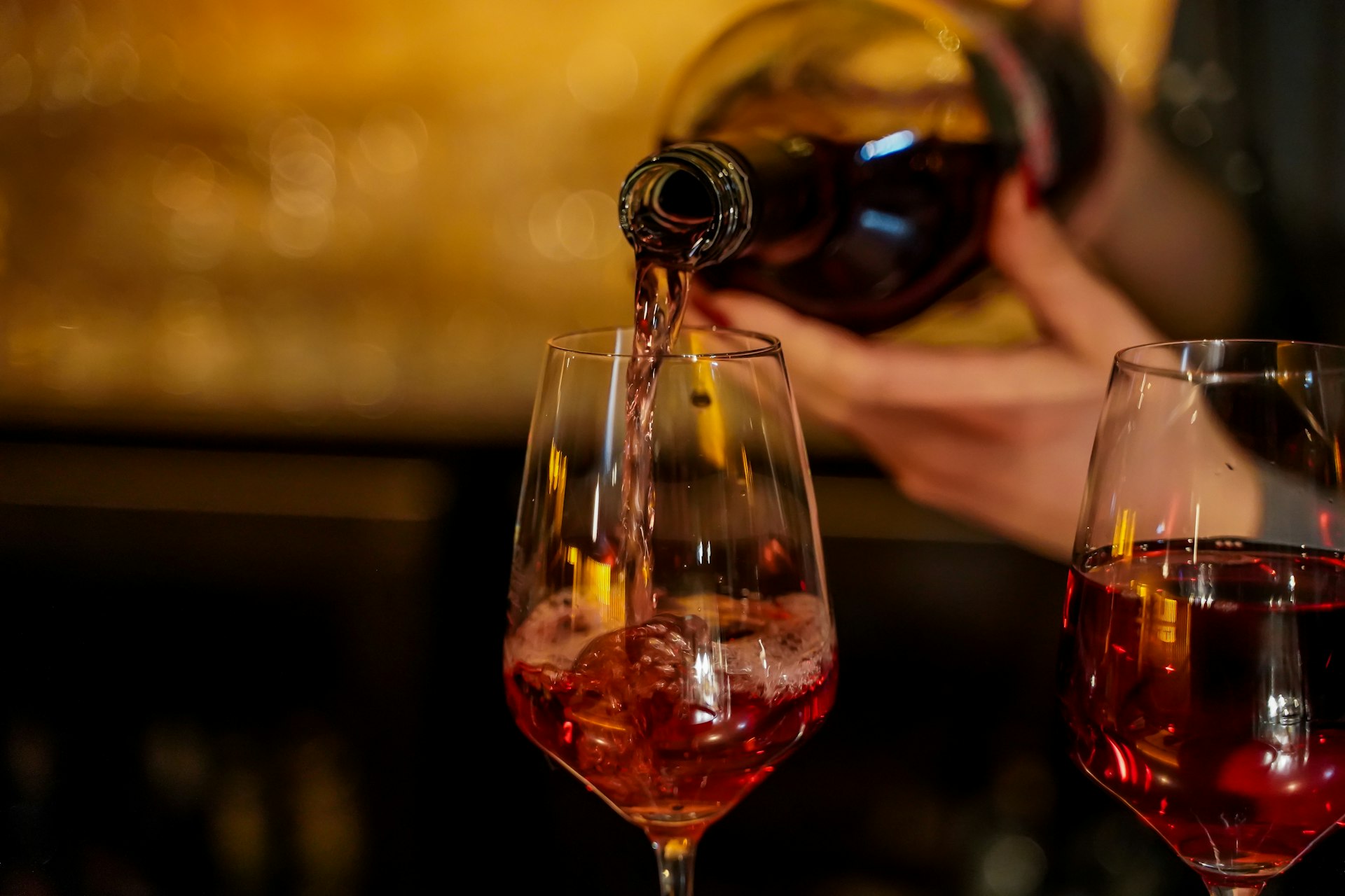 wine bottle pouring on wine glass